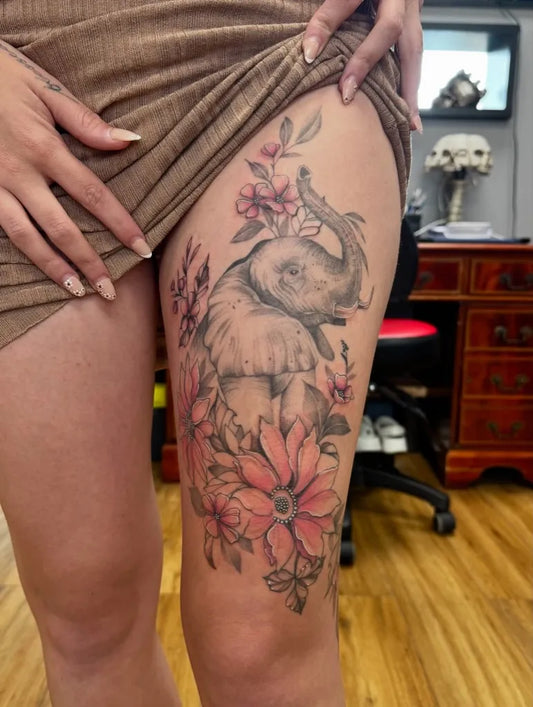 Big Black and Grey Elephant and Flowers Tattoo on Women Thigh by @studio13_crawley