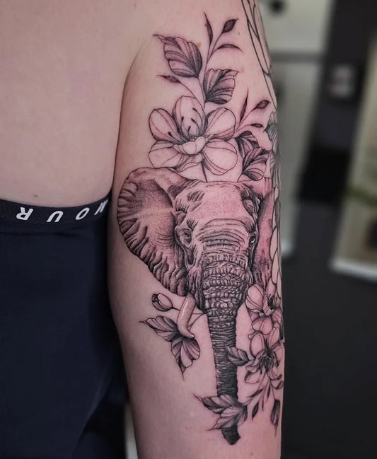 Big Black and Grey Elephant and Flowers Tattoo on Women Upper Arm by @jessharrisart