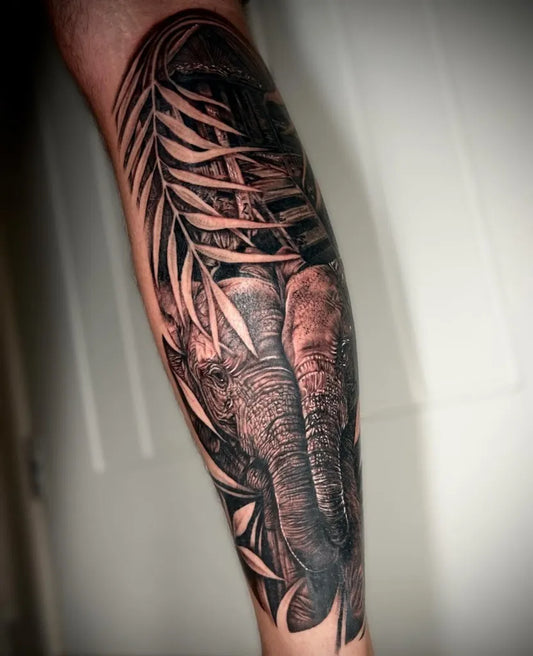 Big Black and Grey Elephant and Palm Leaves Tattoo on Men Calf by @blissinks