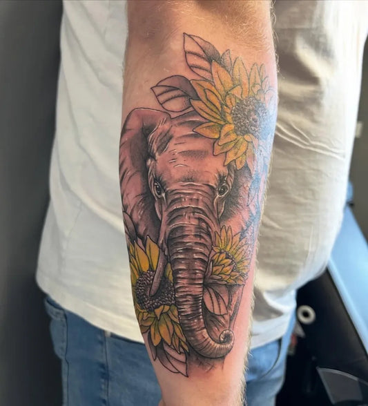 Big Black and Grey Elephant with Sunflowers Tattoo on Men Arm by @cultxiiitattoo