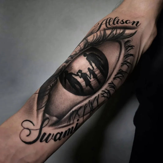 Big Black and Grey Eye with Silhouettes and Names Family Tattoo on Men Arm by @nick.blackheart01