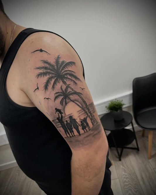 Big Black and Grey Family Under Palm Tree Tattoo on Men Upper Arm by @tattoosbykieran.tbk