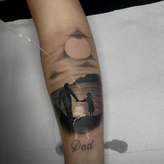 Big Black and Grey Father and Daughter Silhouette with Sunset Landscape Tattoo on Men Arm by @gianluca_tattoo