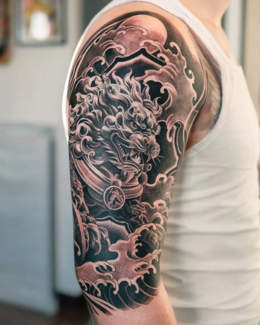 Big Black and Grey Foo Dog with Waves Tattoo on Men Shoulder by @nicolasvalsantattoo