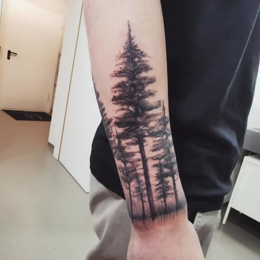 Big Black and Grey Forest Tree Tattoo on Men Arm by @interestink_antonis