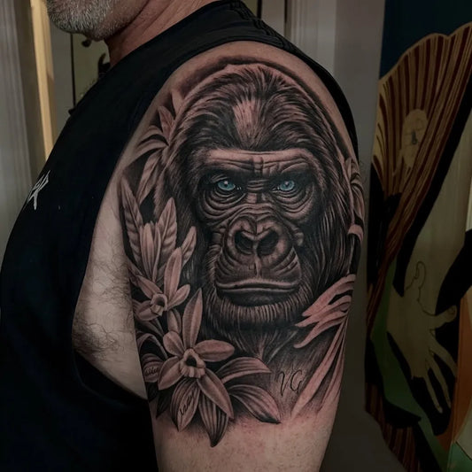 Big Black and Grey Gorilla with Flowers Tattoo on Men Shoulder by @stusblake