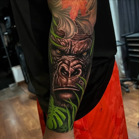 Big Black and Grey Gorilla with Leaves Tattoo on Men Arm by @charli_tat2