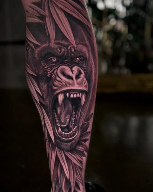 Big Black and Grey Gorilla with Leaves Tattoo on Men Leg by @georgiana113