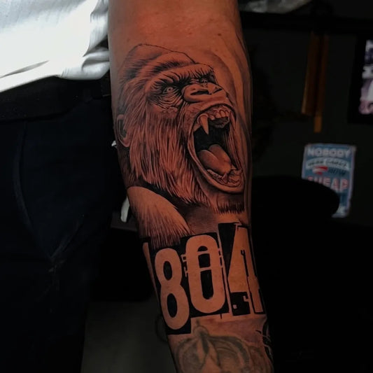 Big Black and Grey Gorilla with Number Tattoo on Men Arm by @millzarte