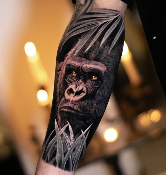 Big Black and Grey Gorilla with Palm Leaves Tattoo on Men Arm by @ammartattoo