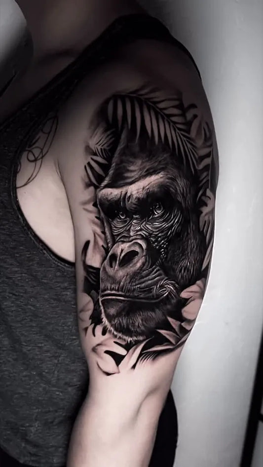 Big Black and Grey Gorilla with Palm Leaves Tattoo on Men Arm by @ladyfoxtattoo