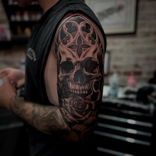 Big Black and Grey Gothic Skull with Rose Tattoo on Men Upper Arm by @winonataylortattoos