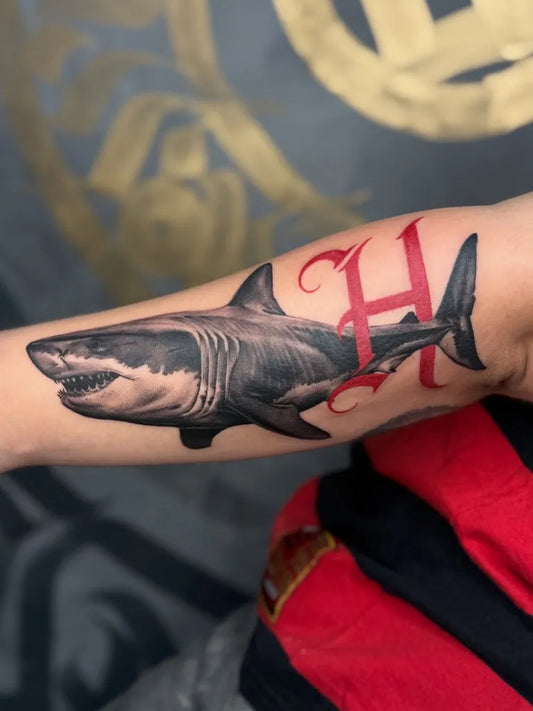 Big Black and Grey Great White Shark with Red H on Men Arm Tattoo by @victorsoarestattoo