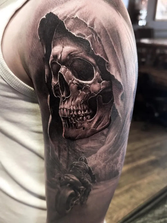 Big Black and Grey Grim Reaper on Motorcycle Tattoo on Men Upper Arm by @rikkileetattoo