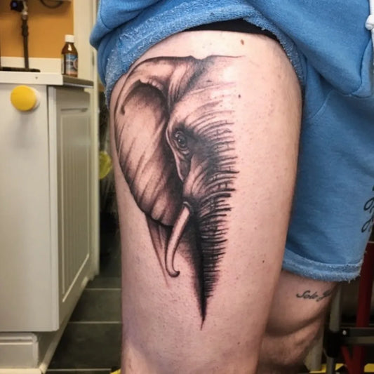 Big Black and Grey Half Elephant Tattoo on Men Thigh by @roryd1982