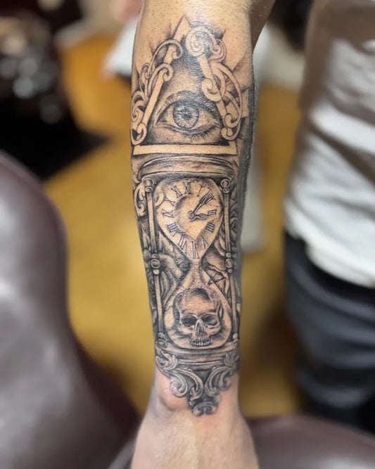Big Black and Grey Hourglass Eye Skull Tattoo on Men Arm by @twotonetattoocompany