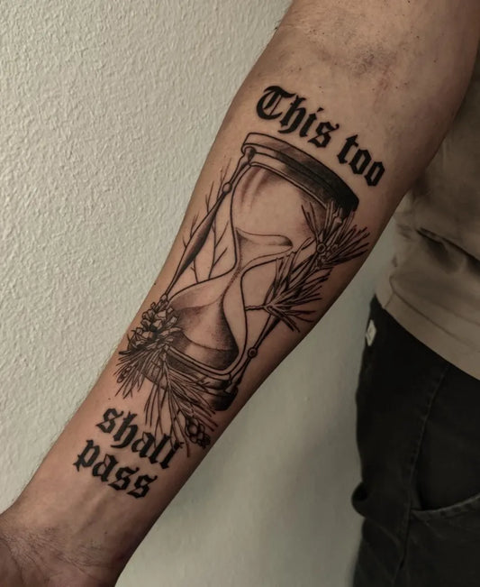 Big Black and Grey Hourglass with Floral Accents Tattoo on Men Arm by @lov.is.ink