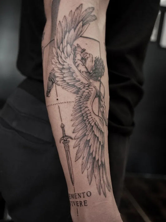 Big Black and Grey Icarus with Wings and Sword on Men Arm Tattoo by @martaliisa.tats