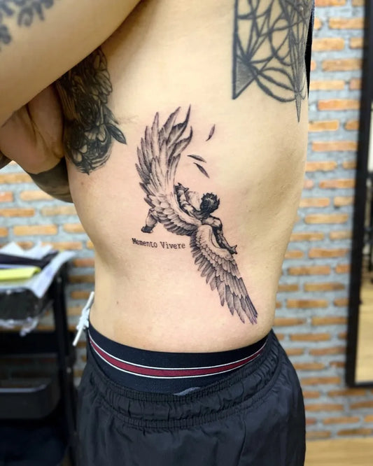 Big Black and Grey Icarus with Wings on Men Rib Tattoo by @rattle_tattoo