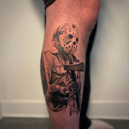 Big Black and Grey Jason Voorhees with Machete Horror Tattoo on Men Thigh by @rhysedmundstattoo