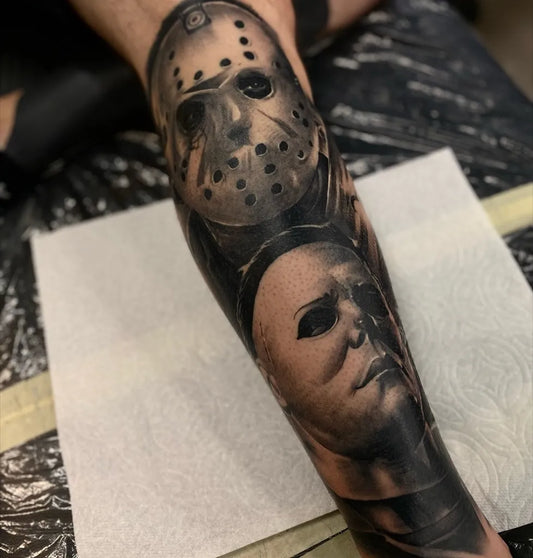 Big Black and Grey Jason and Michael Myers Horror Tattoo on Men Leg by @tattoo.whisper