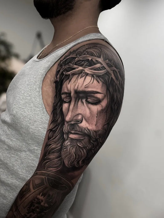 Big Black and Grey Jesus Portrait Tattoo on Men Shoulder by @rinktattoos