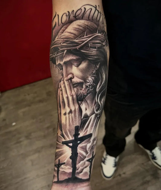 Big Black and Grey Jesus Praying with Crosses Tattoo on Men Arm by @nolanhatton