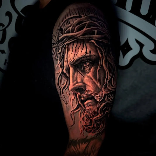 Big Black and Grey Jesus Tattoo on Men Arm by @ortiz.tattoos