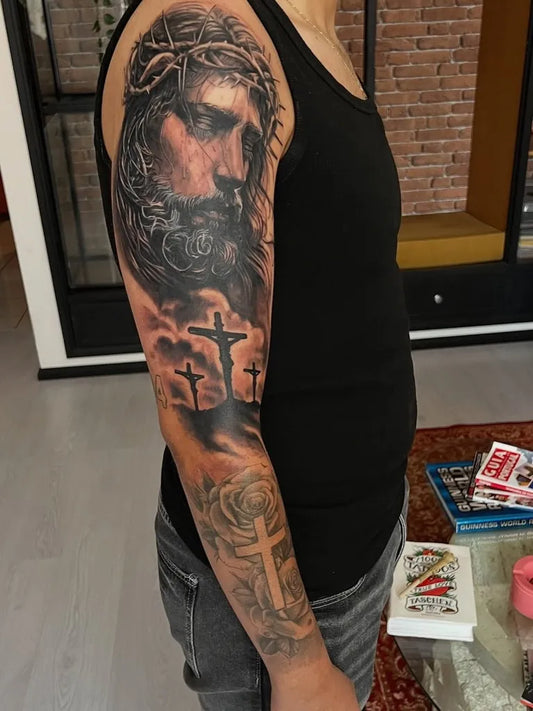 Big Black and Grey Jesus with 3 Cross Tattoo on Men Arm by @imarceloregalado