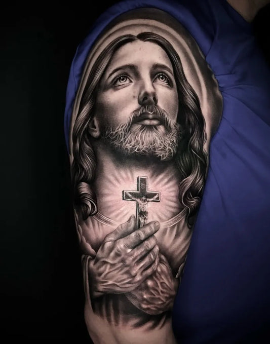 Big Black and Grey Jesus with Cross Tattoo on Men Arm by @marcosmaranhotattoos