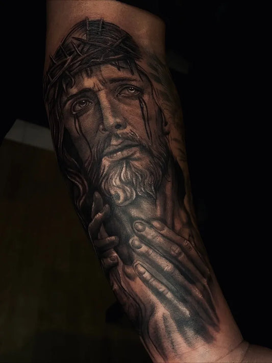 Big Black and Grey Jesus with Crown of Thorns Tattoo on Men Arm by @caliel.ink