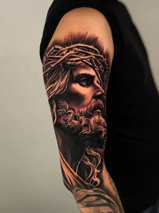 Big Black and Grey Jesus with Crown of Thorns Tattoo on Men Arm by @mager_tattoos