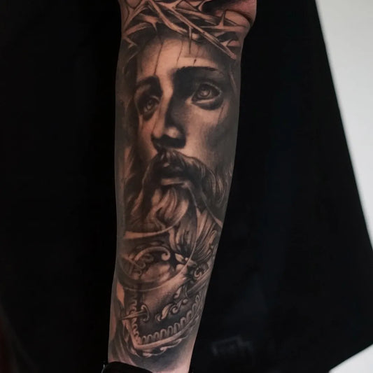 Big Black and Grey Jesus with Crown of Thorns Tattoo on Men Arm by @no.one.tattoo_