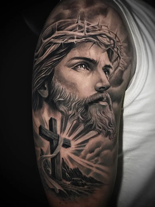Big Black and Grey Jesus with Crown of Thorns and Cross Tattoo on Men Arm by @bobjohntattoo