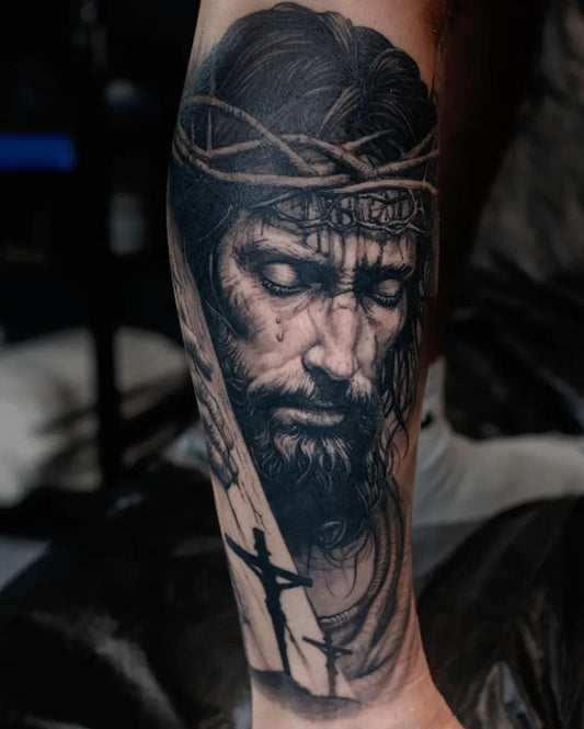 Big Black and Grey Jesus with Crown of Thorns and Cross Tattoo on Men Arm by @jafarlee_tattoo