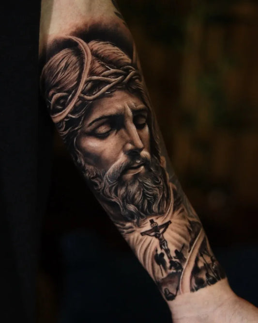 Big Black and Grey Jesus with Crown of Thorns and Cross Tattoo on Men Arm by @marcusmartinstattoo