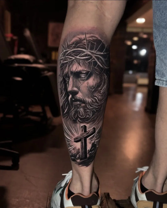 Big Black and Grey Jesus with Crown of Thorns and Cross Tattoo on Men Leg by @originalsptattoo_moema