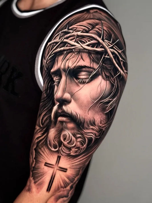 Big Black and Grey Jesus with Crown of Thorns and Cross Tattoo on Men Shoulder by @melta.ttoo