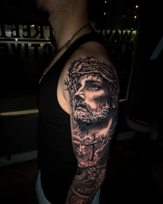 Big Black and Grey Jesus with Crown of Thorns and Cross Tattoo on Men Upper Arm by @ink_by_cy