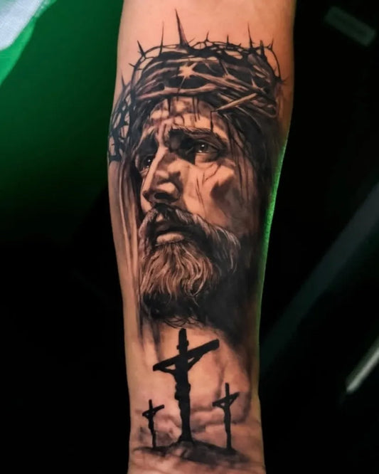 Big Black and Grey Jesus with Crown of Thorns and Crosses Tattoo on Men Arm by @blackswantattoo.htx0925