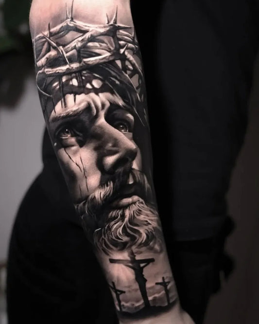 Big Black and Grey Jesus with Crown of Thorns and Crosses Tattoo on Men Arm by @prime_ink_tattoo_muenchen