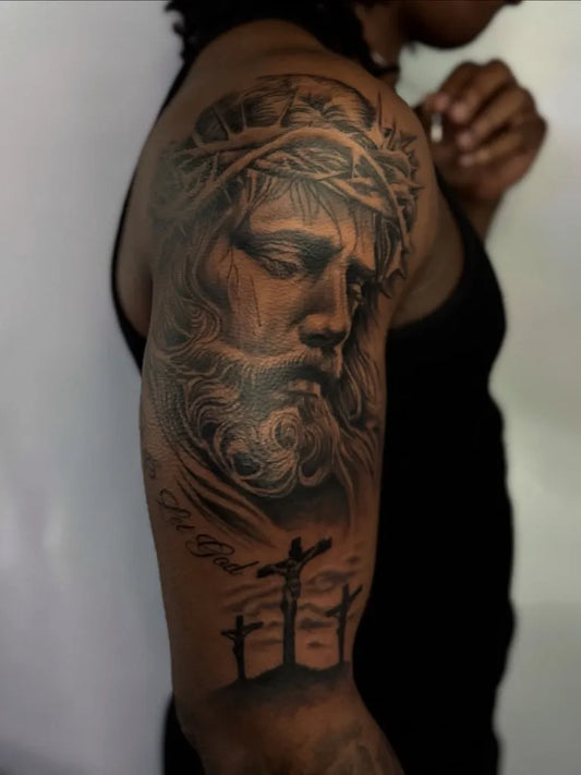 Big Black and Grey Jesus with Crown of Thorns and Crosses Tattoo on Men Upper Arm by @dapzink