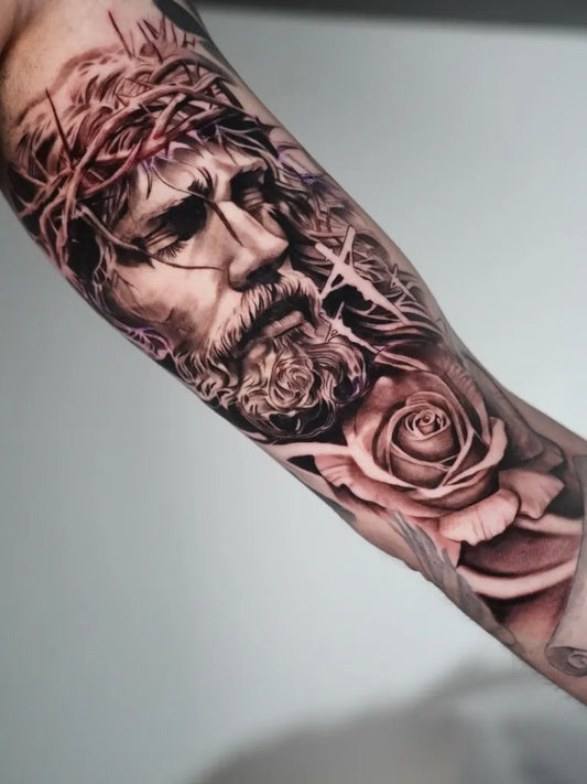 Big Black and Grey Jesus with Crown of Thorns and Rose Tattoo on Men Arm by @onepercenttattoo