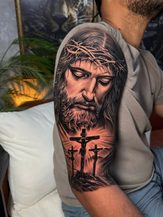 Big Black and Grey Jesus with Crown of Thorns and Three Crosses Tattoo on Men Shoulder by @bieltattoo_
