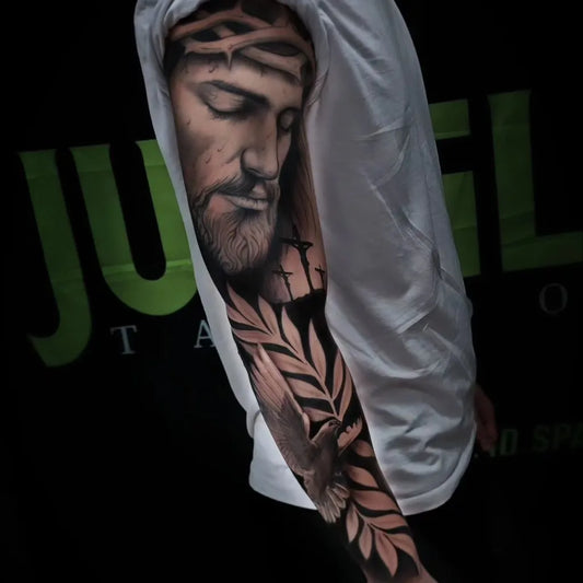 Big Black and Grey Jesus with Dove and Laurel Tattoo on Men Arm by @devid.spagnuolo.tattoo