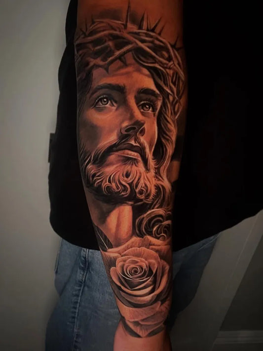 Big Black and Grey Jesus with Roses Tattoo on Men Arm by @jorgerosales_tattoos