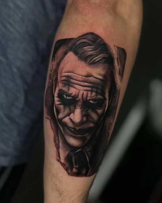 Big Black and Grey Joker Portrait on Men Arm Tattoo by @cyrascott_tattoo
