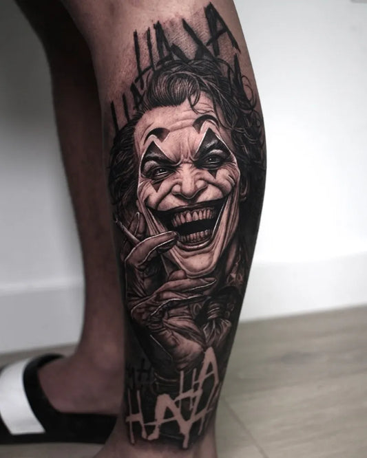 Big Black and Grey Joker laughing on Men Leg Tattoo by @carlosharftattoo