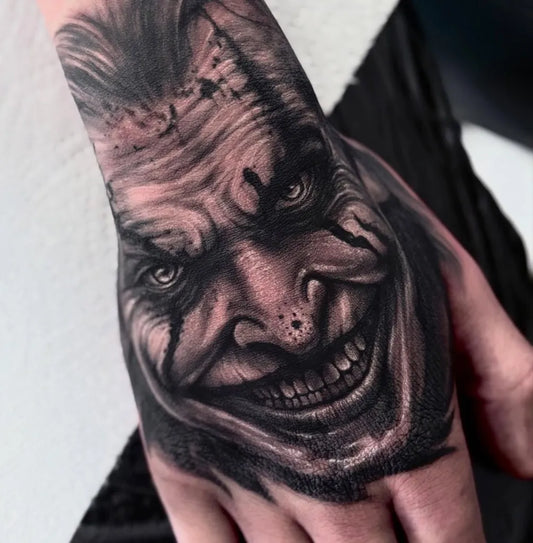 Big Black and Grey Joker on Men Hand Tattoo by @ravstattoos