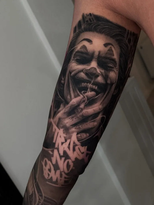 Big Black and Grey Joker with Graffiti Text on Men Arm Tattoo by @cristi_tudorr